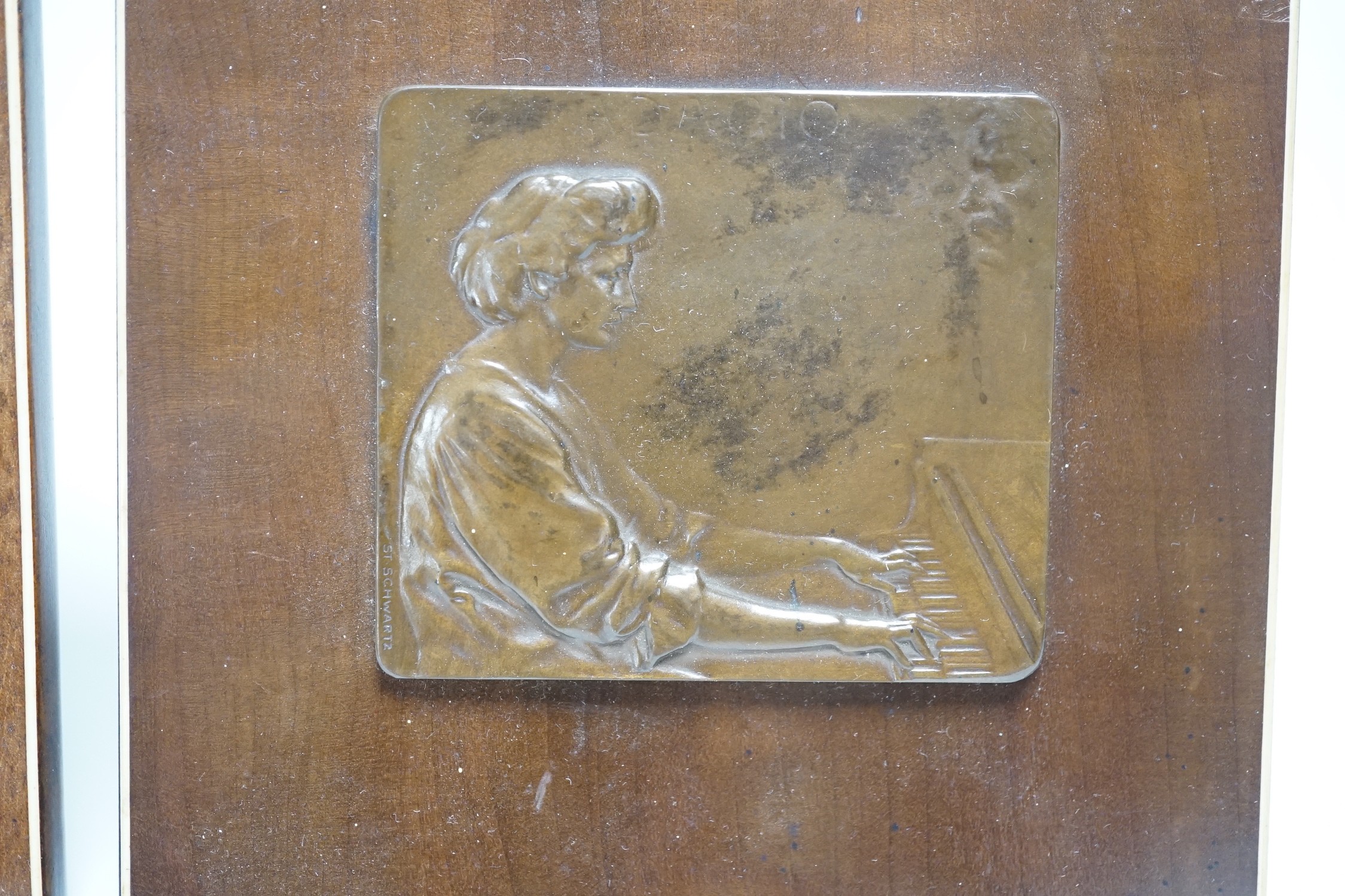 Two Stefan Schwartz bronze relief plaque, mounted on mahogany easels. Largest easel 16cm sq and an Art of Parqueter Mosaic Puzzle, Germany